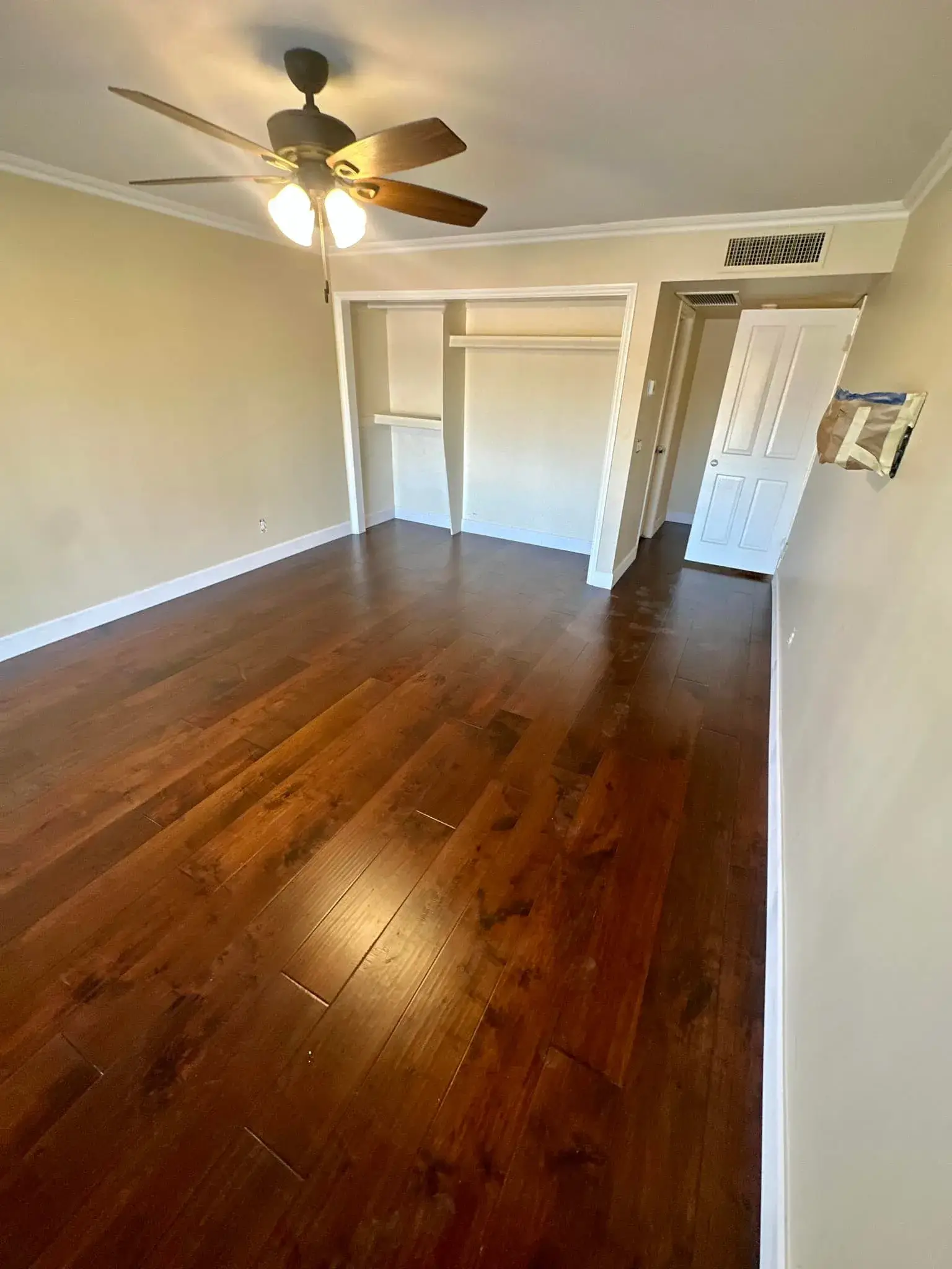 Newly installed dark-stained hand-scraped hardwood flooring in an Arizona bedroom by Zona Floors
