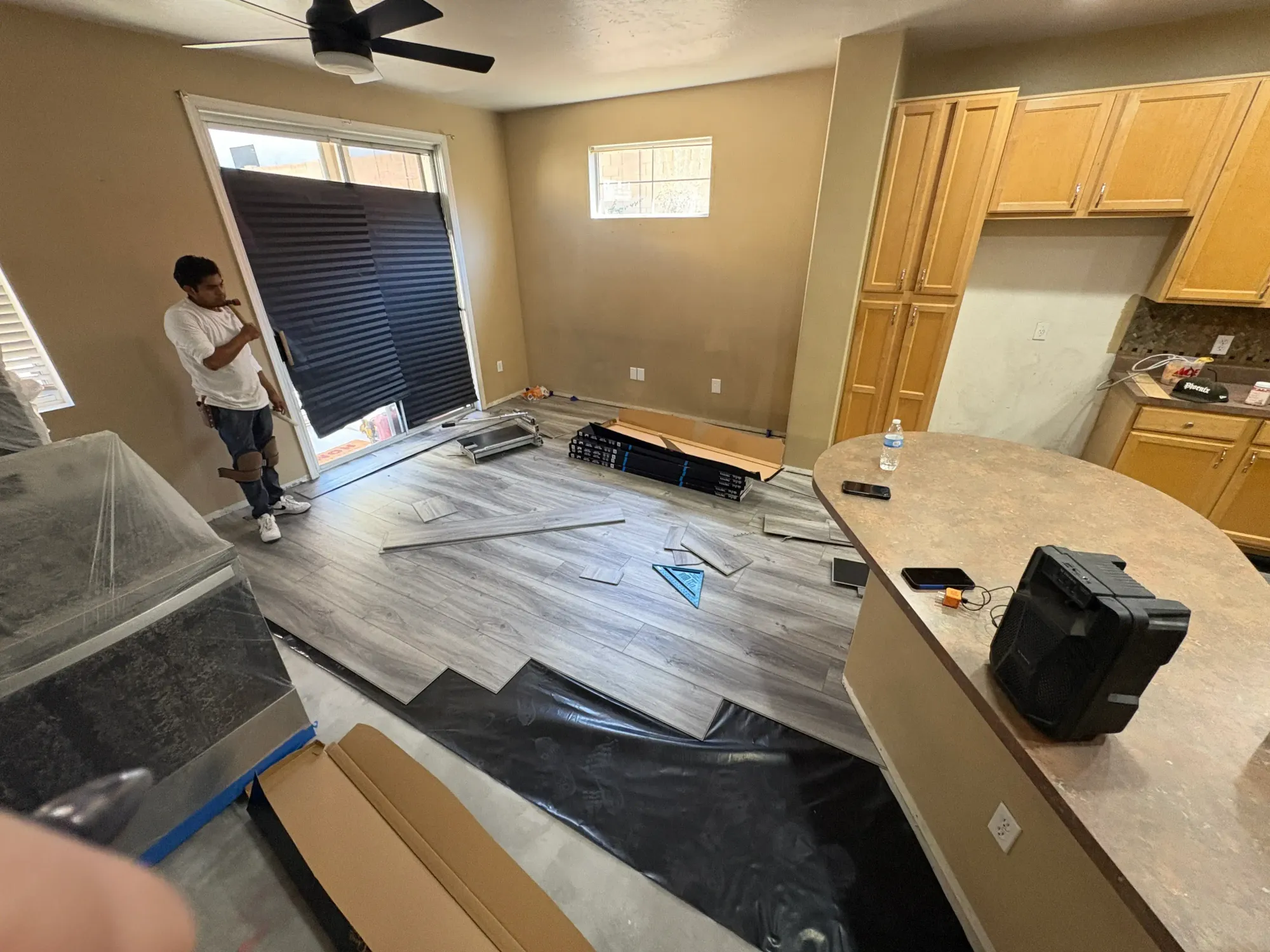 Zona Floors installer laying luxury vinyl plank flooring in an Arizona home
